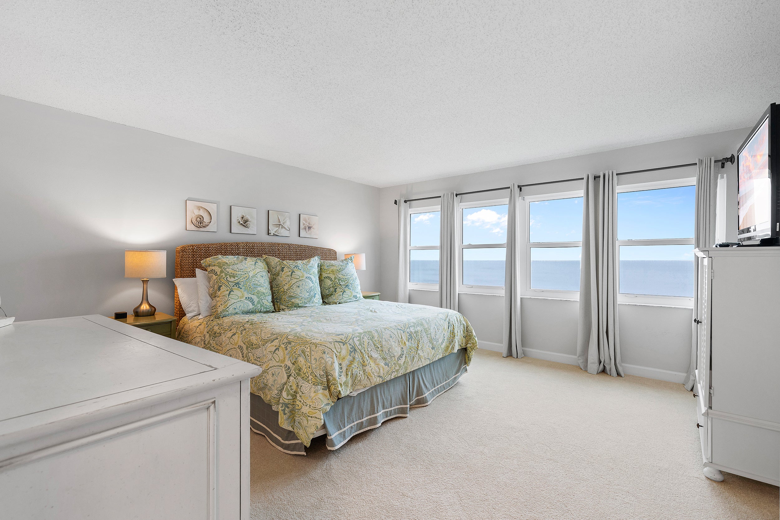Spacious primary bedroom with ocean views