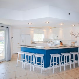 Bright white kitchen with blue accent