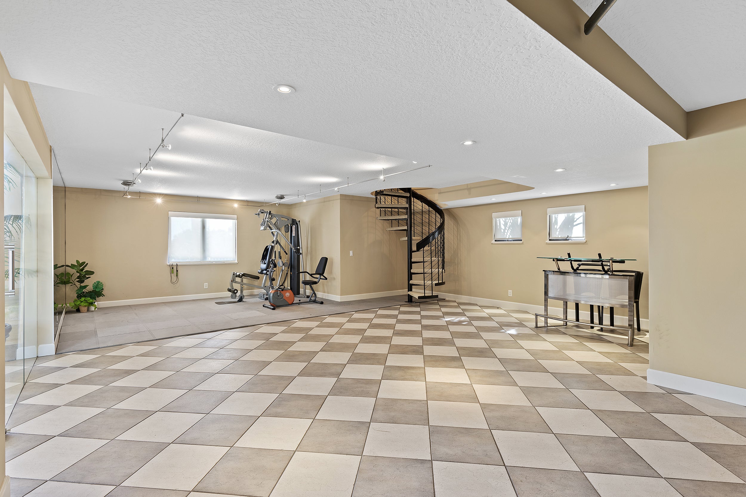 Huge garage, exercise machine, and spiral staircase