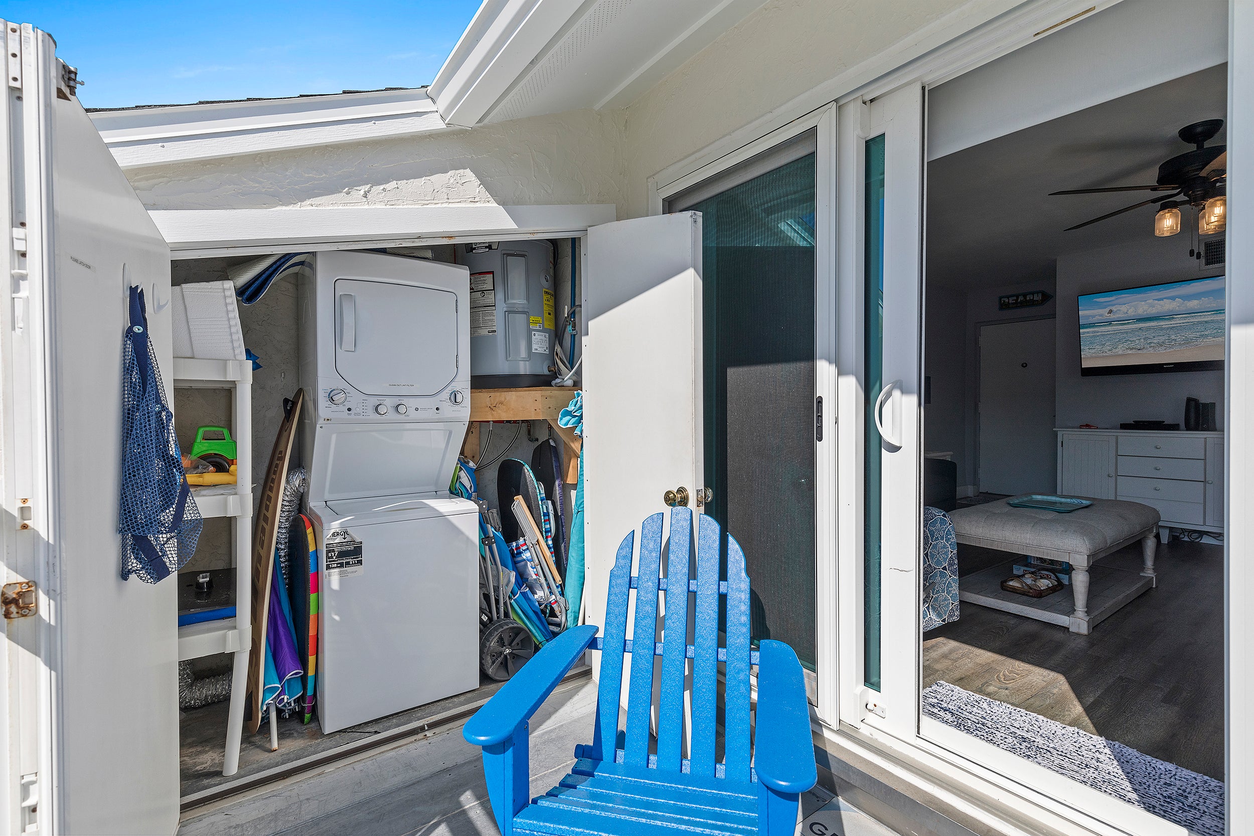 Stackable washer/dryer in patio storage.