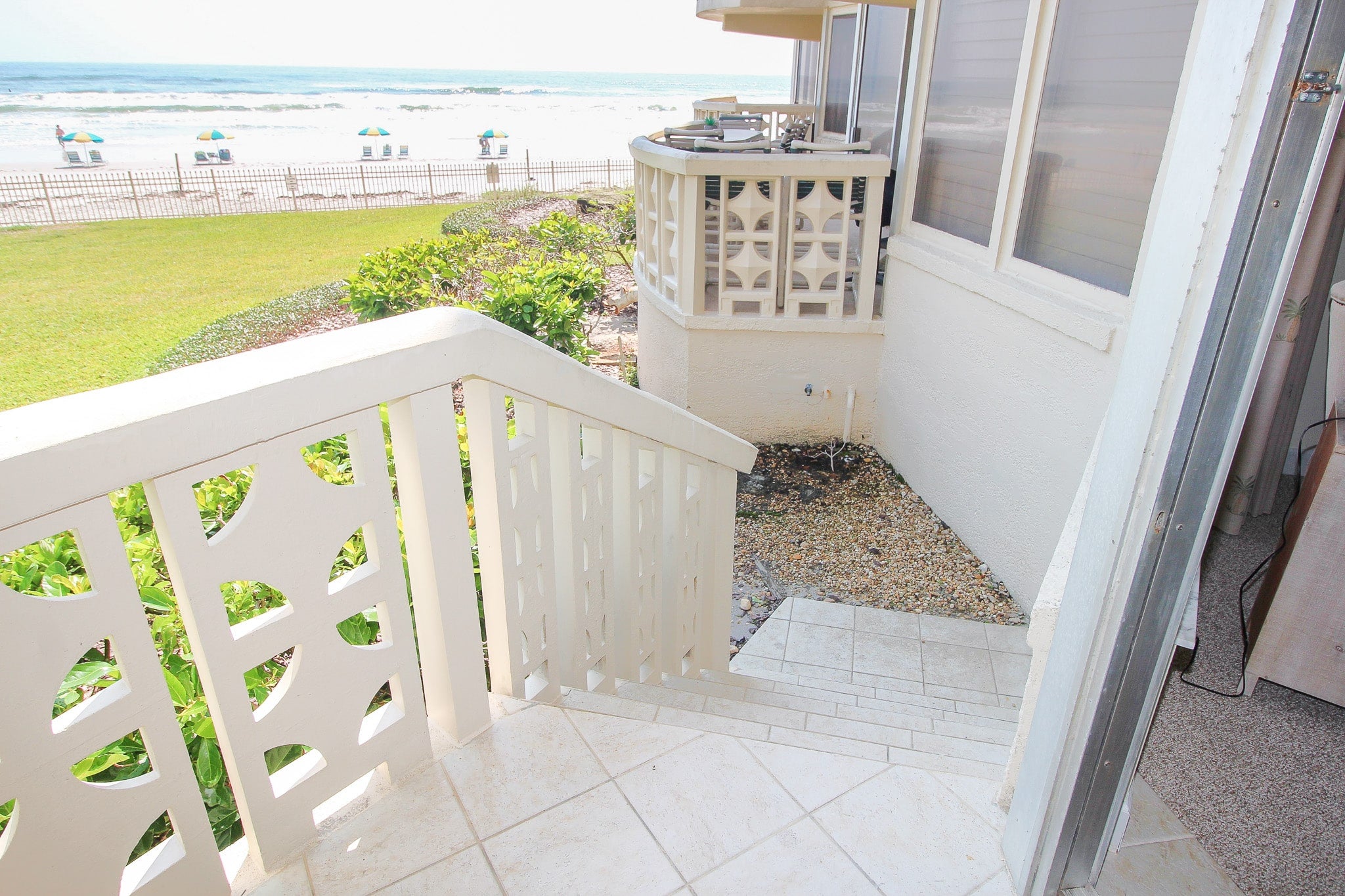 Stairs from balcony providing direct access to pool and beach